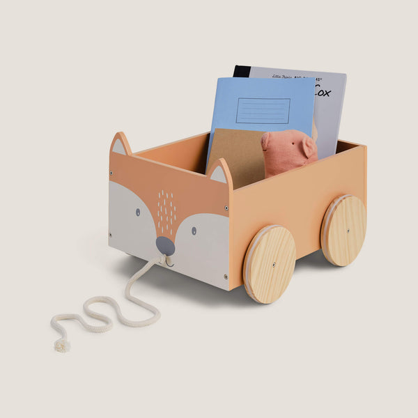 Wooden toy cart shaped like a fox with wheels on a light beige background