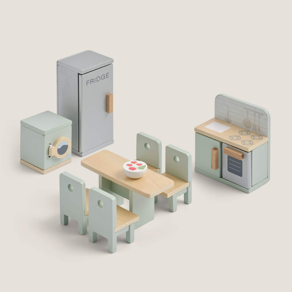 Set of toy kitchen furniture including a refrigerator, dining table with chairs, and cabinets on a light beige background.
