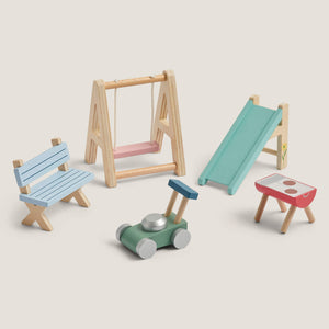 Set of colorful wooden toys including a swing, slide, bench, and cart on a light background