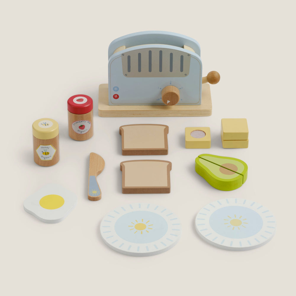 Wooden toy kitchen set with toaster, avocado, toast, and eggs on a beige background