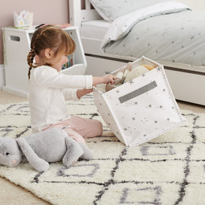 Child playing with canvas storage cube	