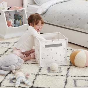 child playing with a canvas storage cube	