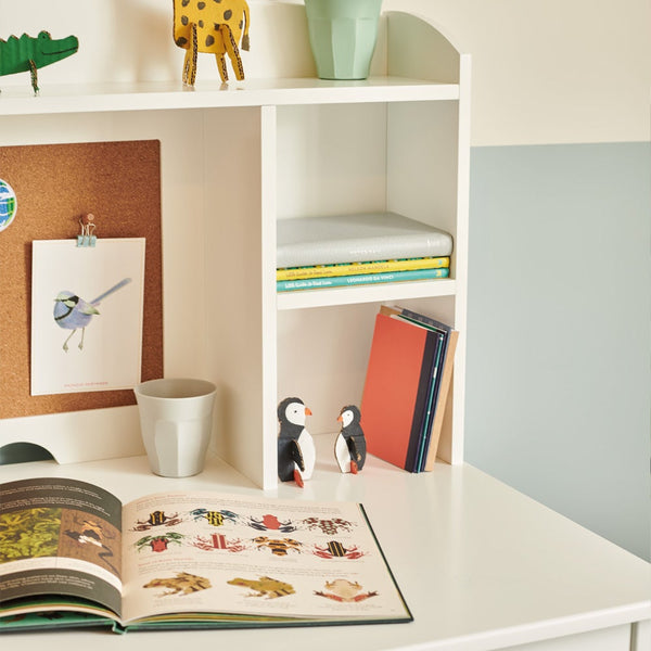 close-up of tall whittington desk with books and toys	