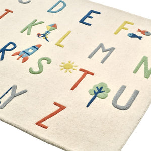 Children's alphabet rug with colorful letters and symbols on a white background